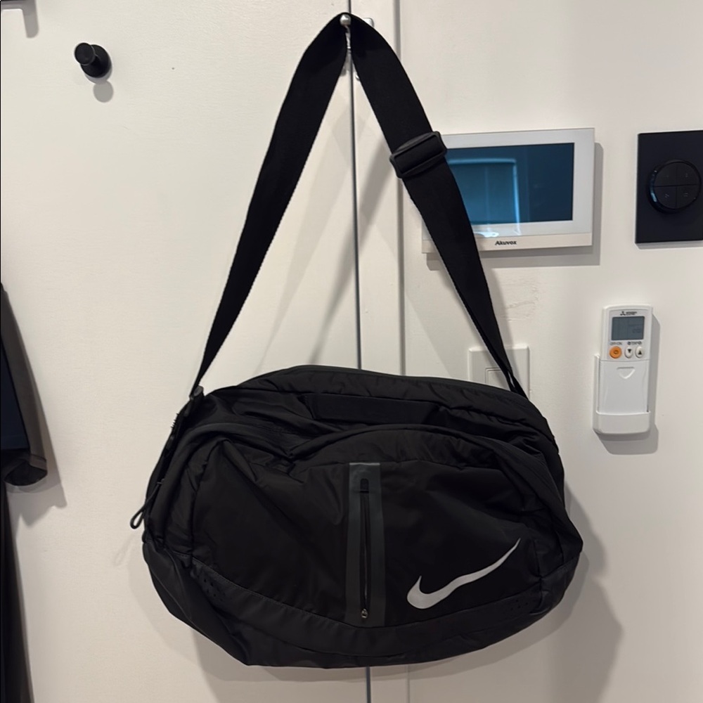Nike Black Duffel Bag with Iconic Swoosh and Adjustable Strap